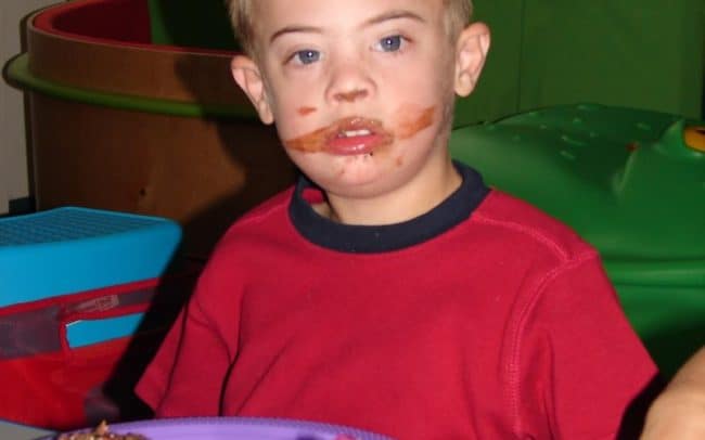 kid with cupcake on his face