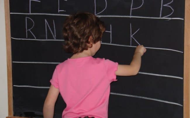 kid at chalk board