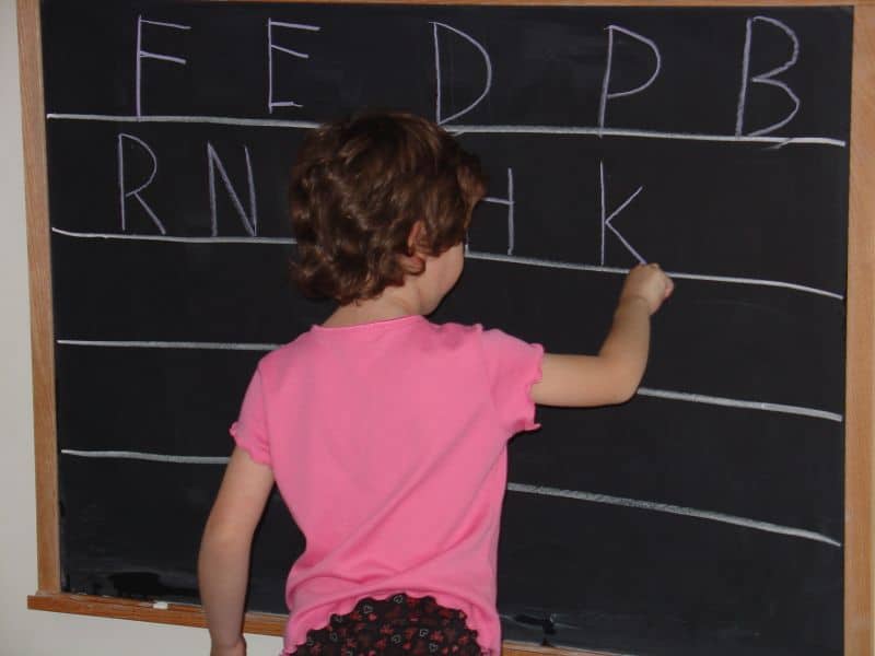 child at chalkboard