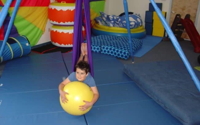 kid suspended on playground equipment