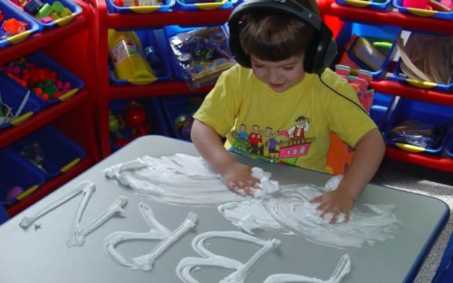kid working with letters and paste